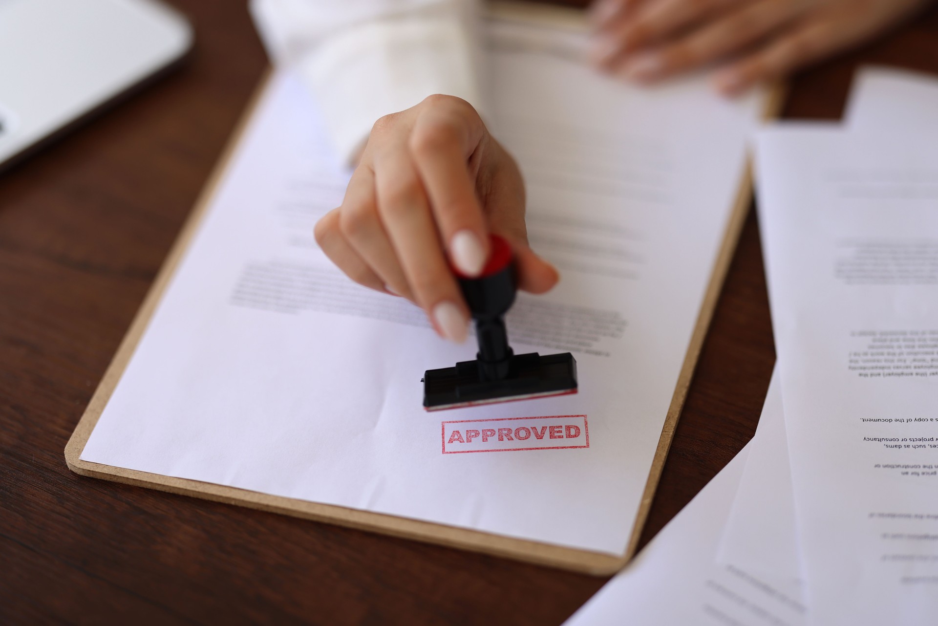 Real estate trade real estate agent employee holding puts stamp for sale approval